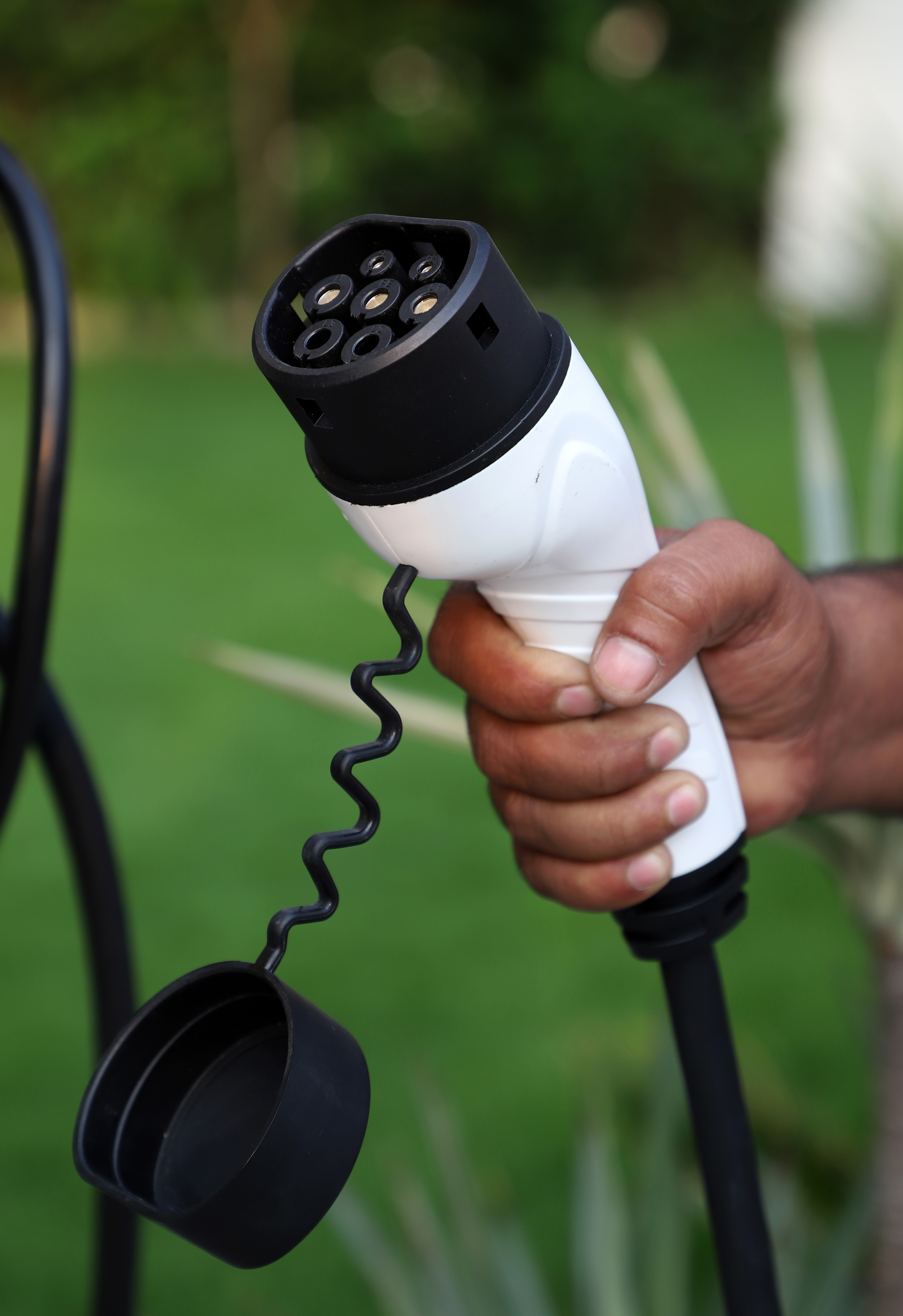 A row of EV chargers in a public parking area